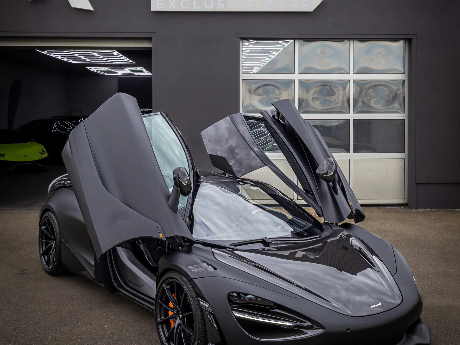 McLaren 750S mit geöffneten Türen vor dem Showroom